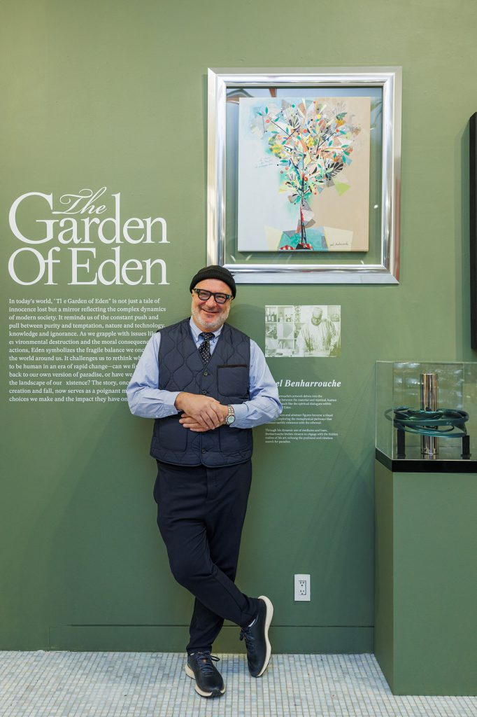 Yoel Benharrouche beside an artwork at The Garden of Eden exhibition
