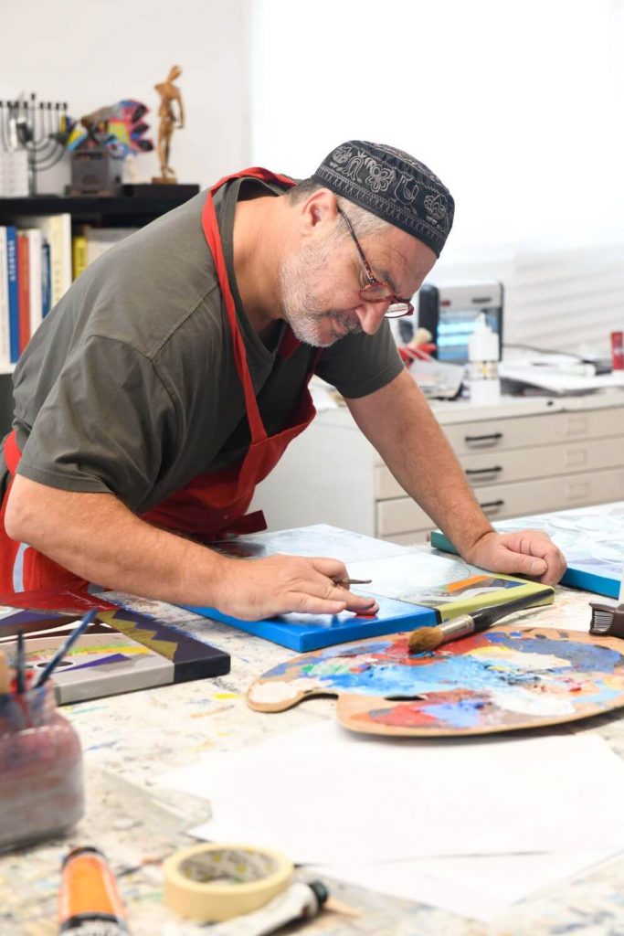 Yoel Benharrouche painting in his studio
