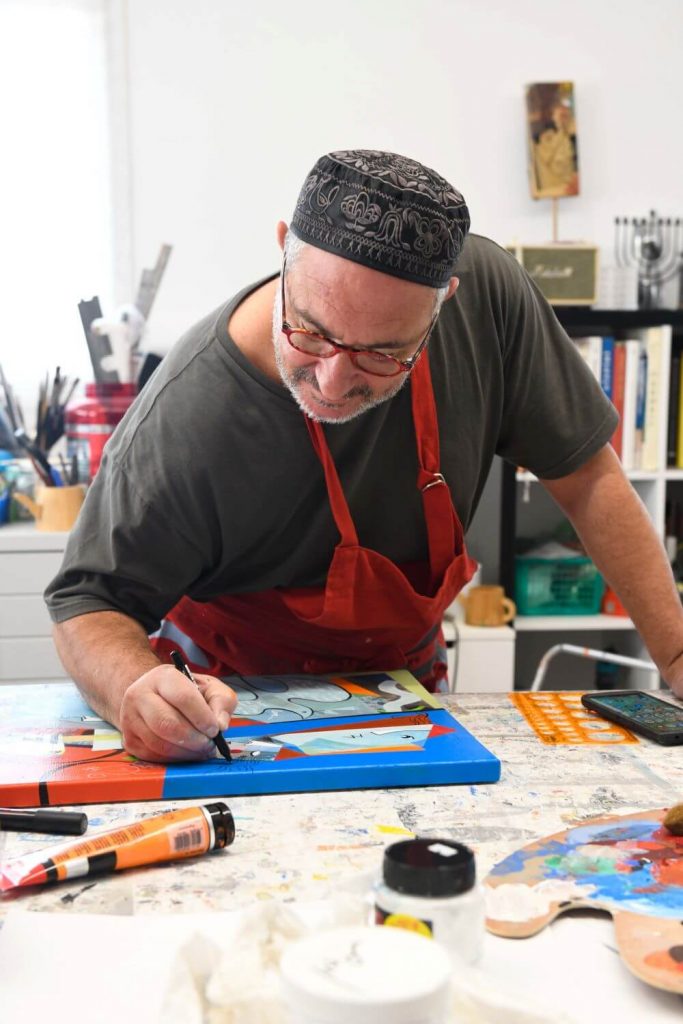 Yoel Benharrouche drawing details on a painting