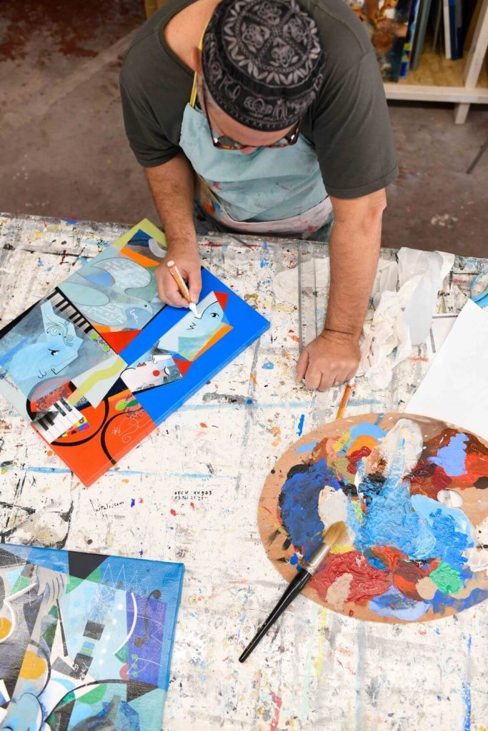 Yoel Benharrouche working on a colorful painting